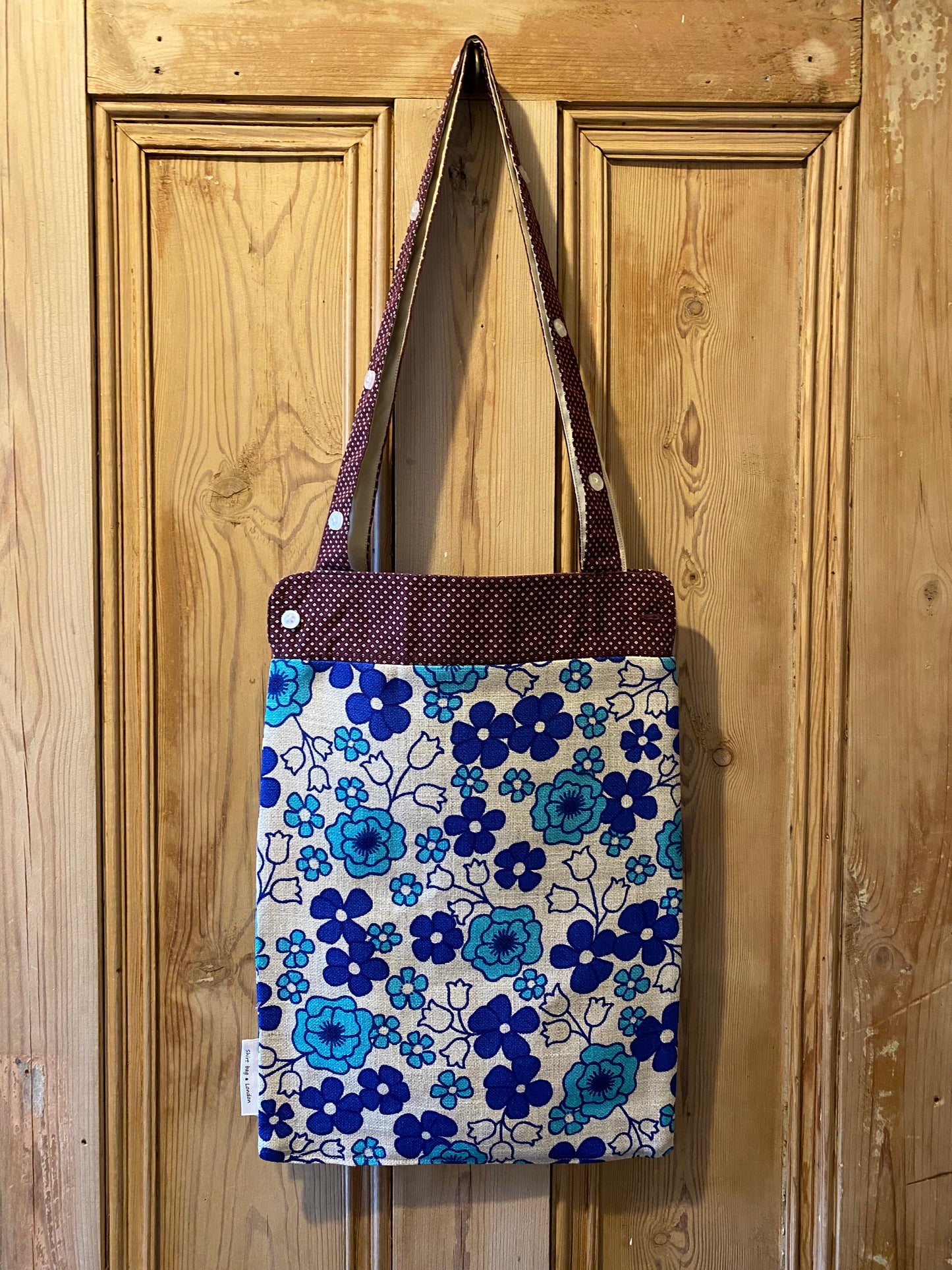 White spots on maroon cuff with blue flowers on beige